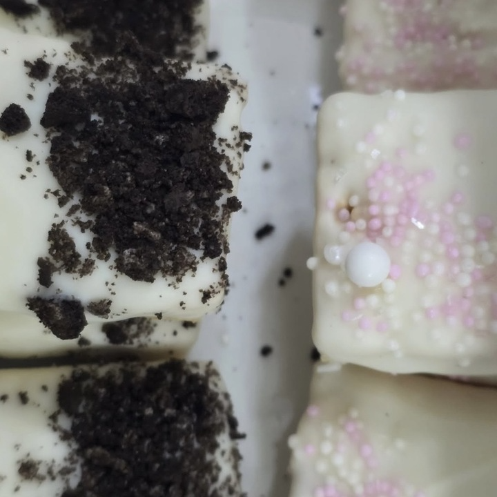 White chocolate cake bites with Oreo crumble and sprinkles